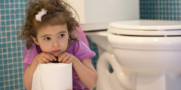 little girl sitting on the potty in the bathroom